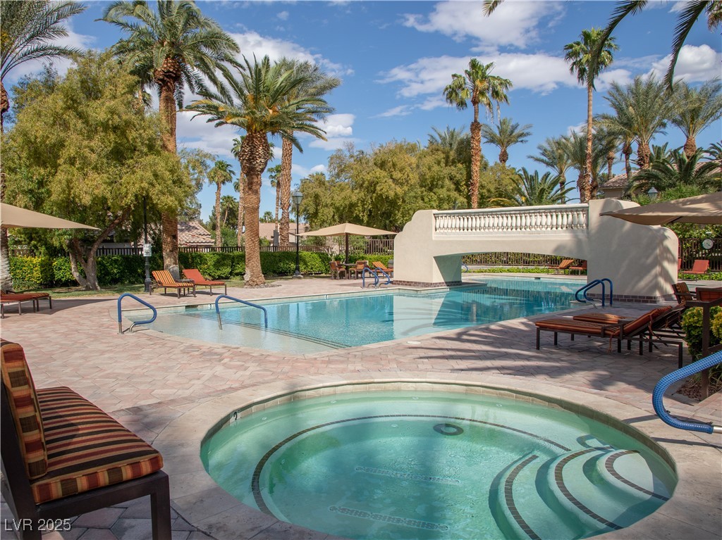 2050 West Warm Springs Road, Unit 411 Henderson, NV 89014 - Photo 22 of 30 Community pool with fence, a hot tub, and a patio area