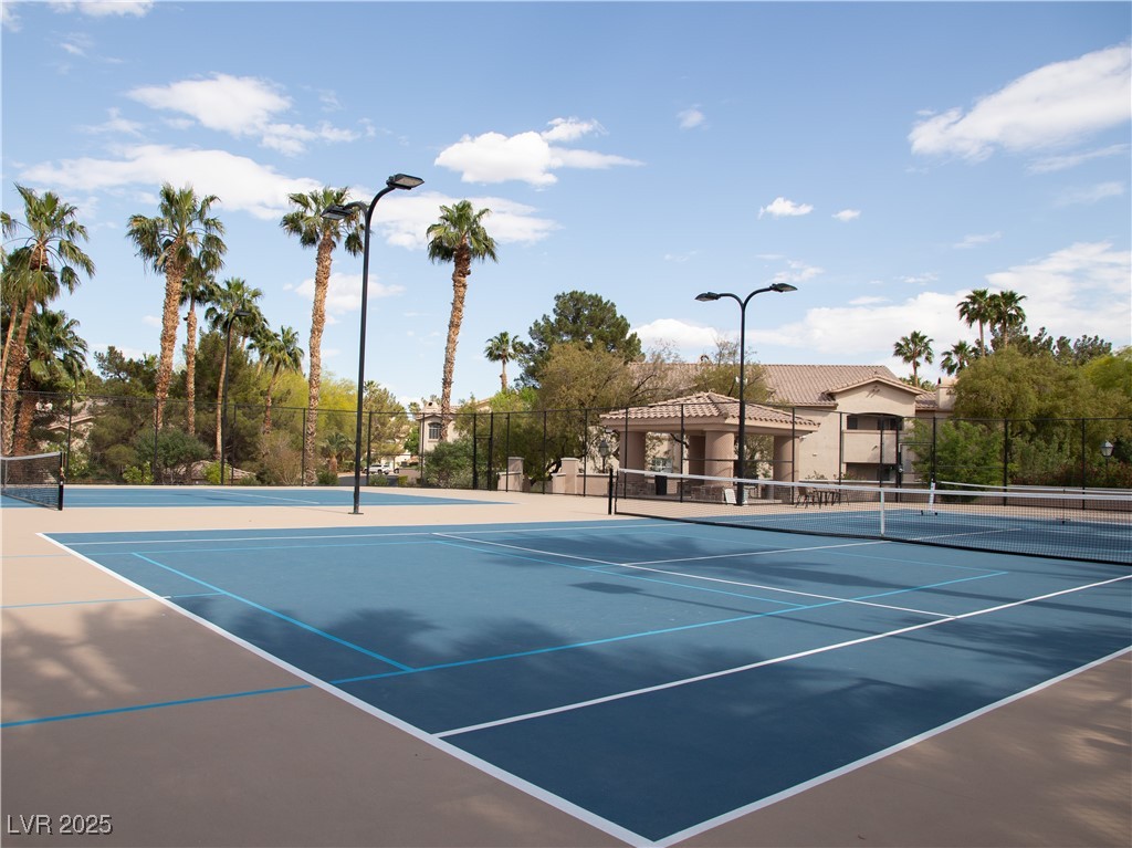 2050 West Warm Springs Road, Unit 411 Henderson, NV 89014 - Photo 24 of 30 View of tennis court featuring fence and community basketball court