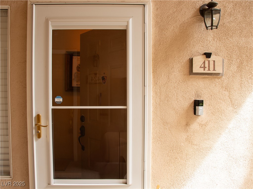2050 West Warm Springs Road, Unit 411 Henderson, NV 89014 - Photo 28 of 30 Doorway to property with stucco siding