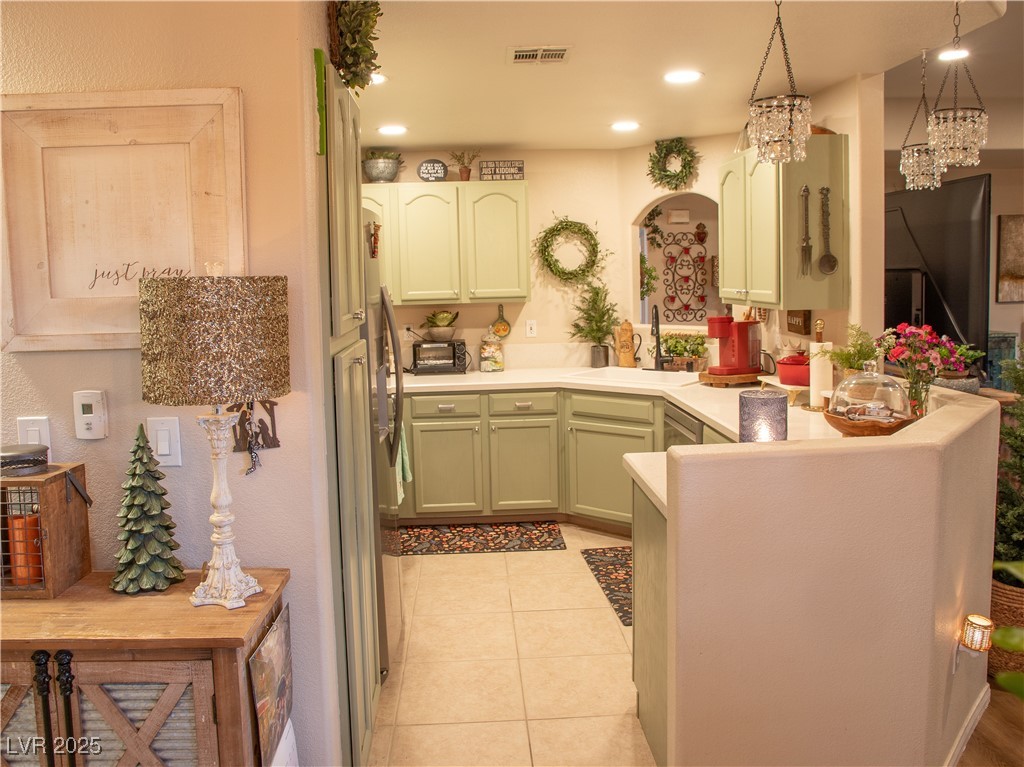 2050 West Warm Springs Road, Unit 411 Henderson, NV 89014 - Photo 6 of 30 Kitchen with a sink, arched walkways, a peninsula, light tile patterned floors, and visible vents