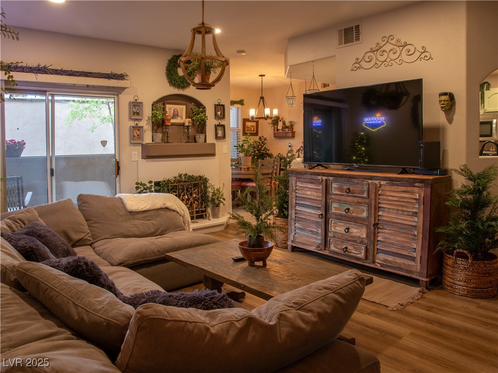 2050 West Warm Springs Road, Unit 411 Henderson, NV 89014 - Photo 10 of 30 Living room featuring a chandelier, visible vents, wood finished floors, and recessed lighting
