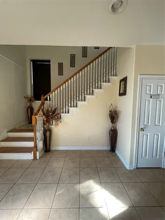 a view of entryway with stairs and windows