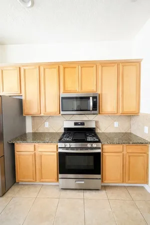 a kitchen with a stove a sink and a microwave