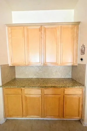 a kitchen with granite countertop cabinets sink and window