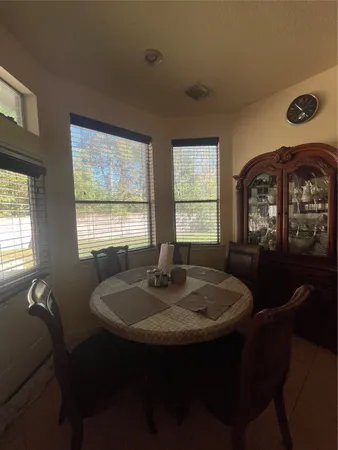 a dining room with furniture and window