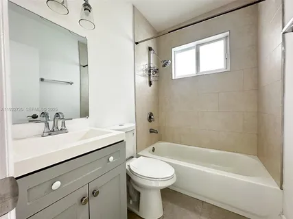 a bathroom with a sink a toilet and a bathtub