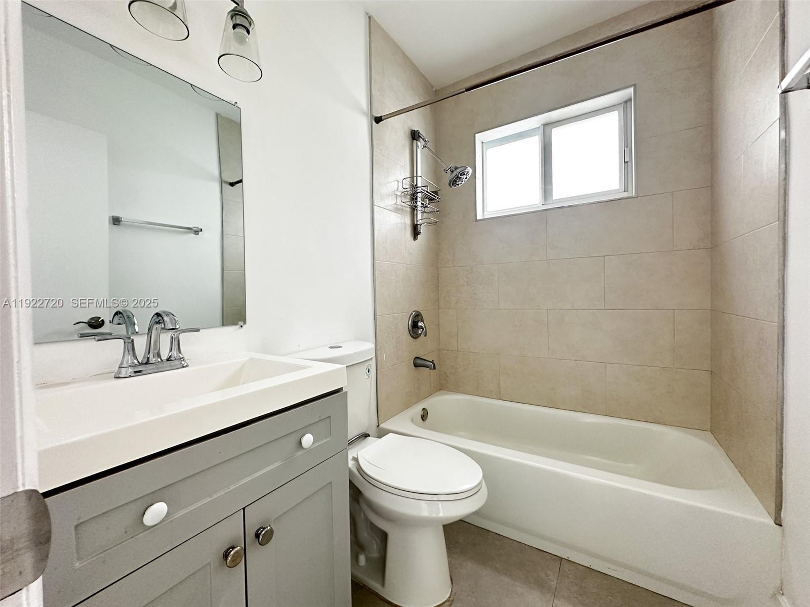 1894 Northwest 53rd Street, Unit A Miami, FL 33142 - Photo 10 of 10 a bathroom with a sink a toilet and a bathtub
