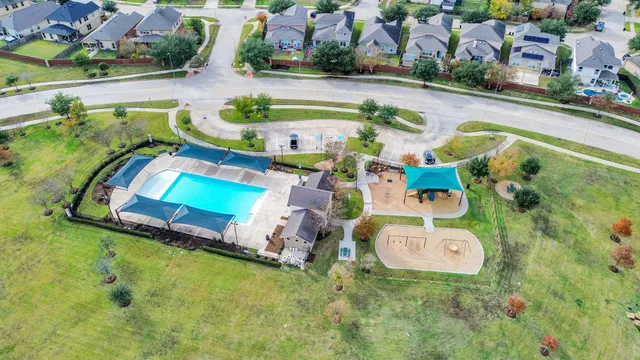 an aerial view of residential house with outdoor space and swimming pool