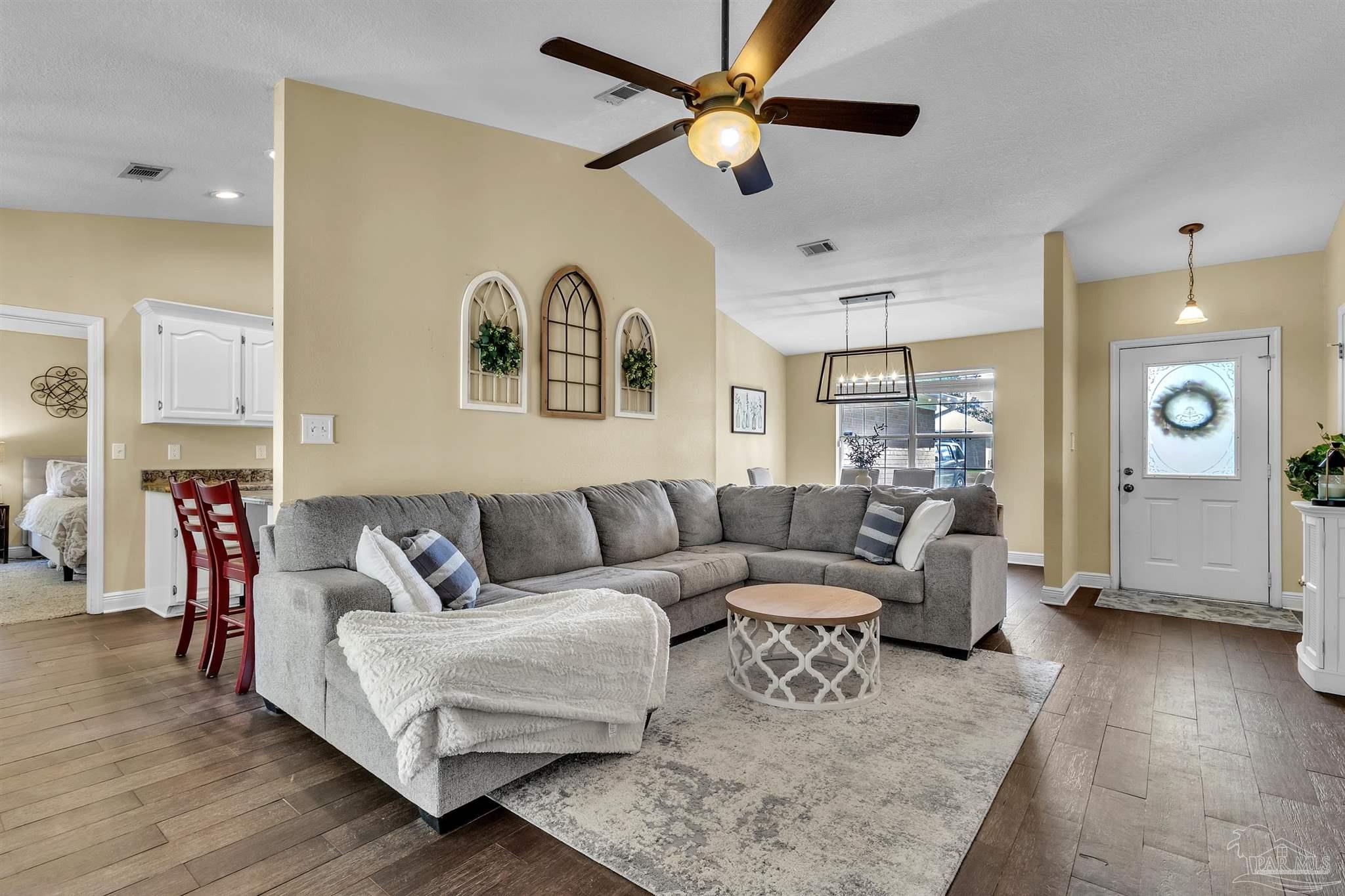 4321 Ridgeland Drive Pace, FL 32571 - Photo 4 of 36 a living room with furniture and a chandelier