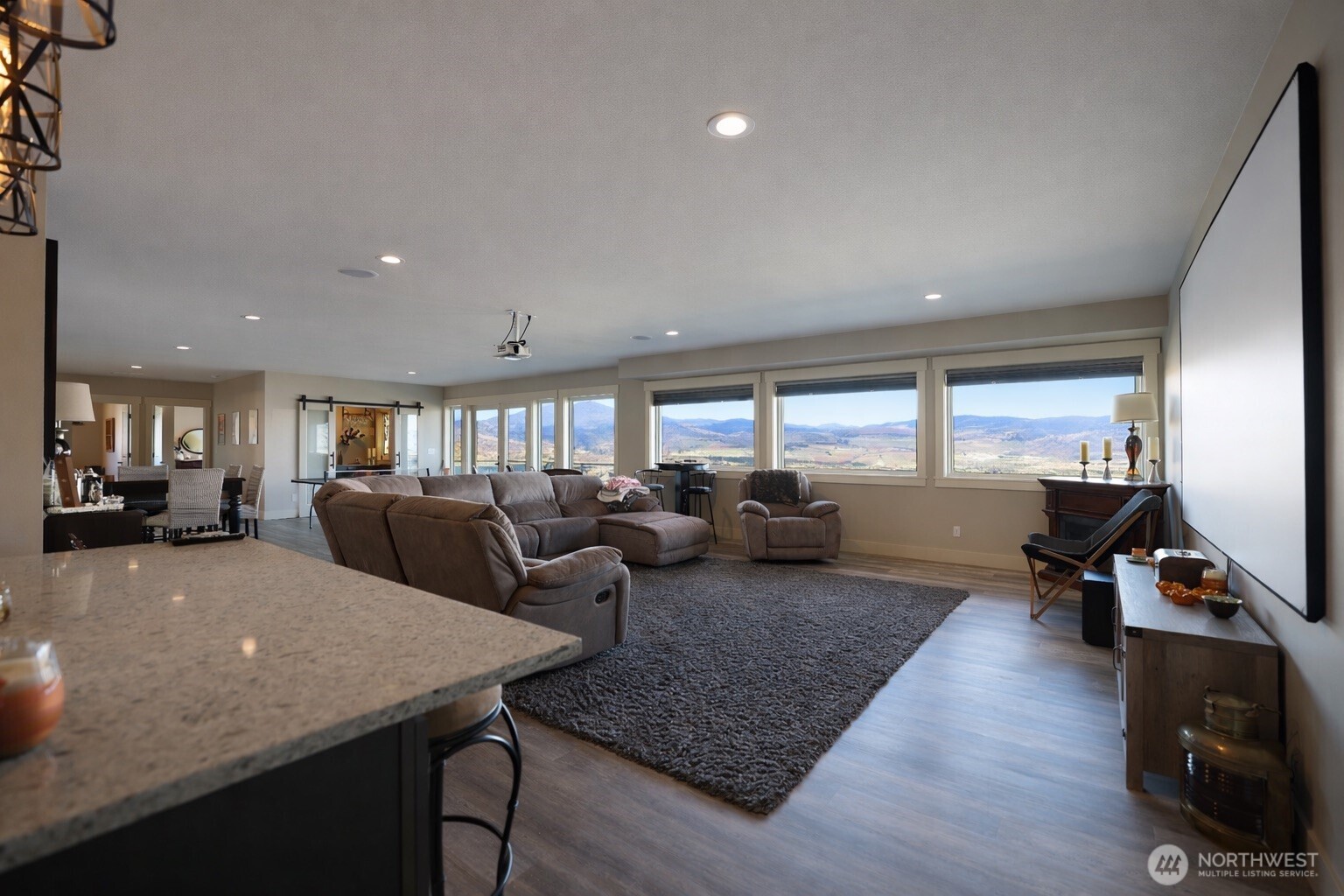 149 Clos Chevalle Road Chelan, WA 98816 - Photo 26 of 37 a living room with lots of furniture and a wooden floor