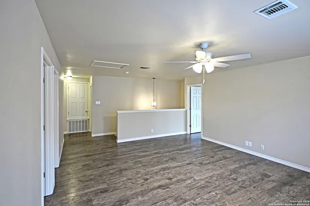 wooden floor in an empty room with a window