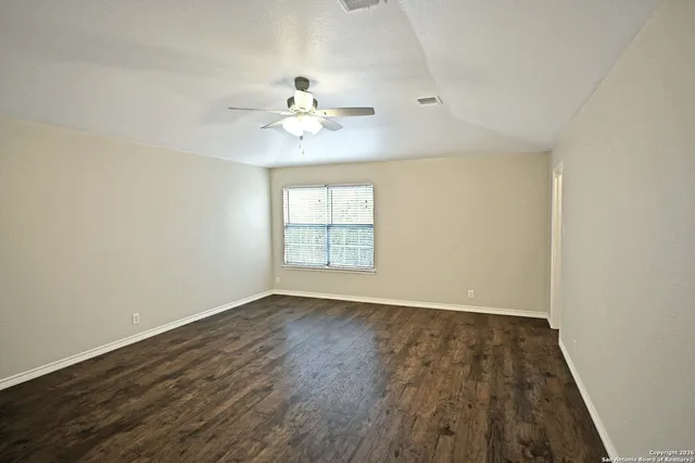 wooden floor in an empty room with a window