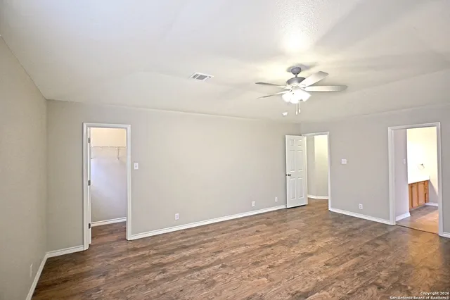 an empty room with fan and a ceiling fan