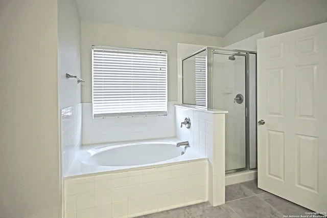 a bathroom with a bathtub and a shower