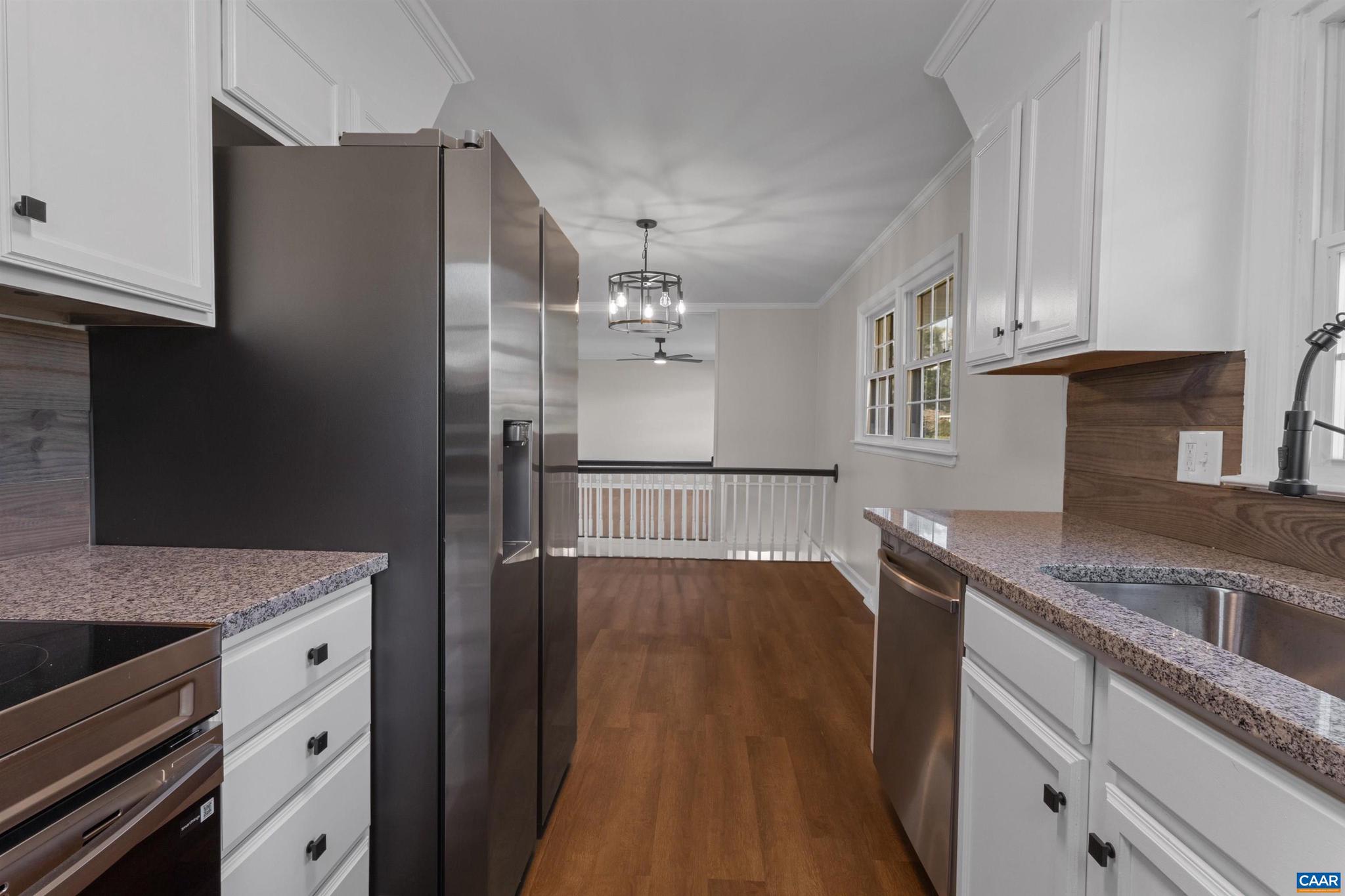 3053 Woodway Road Roanoke, VA 24014 - Photo 11 of 33 a kitchen with stainless steel appliances granite countertop a refrigerator a sink dishwasher a stove and white countertops with wooden floor