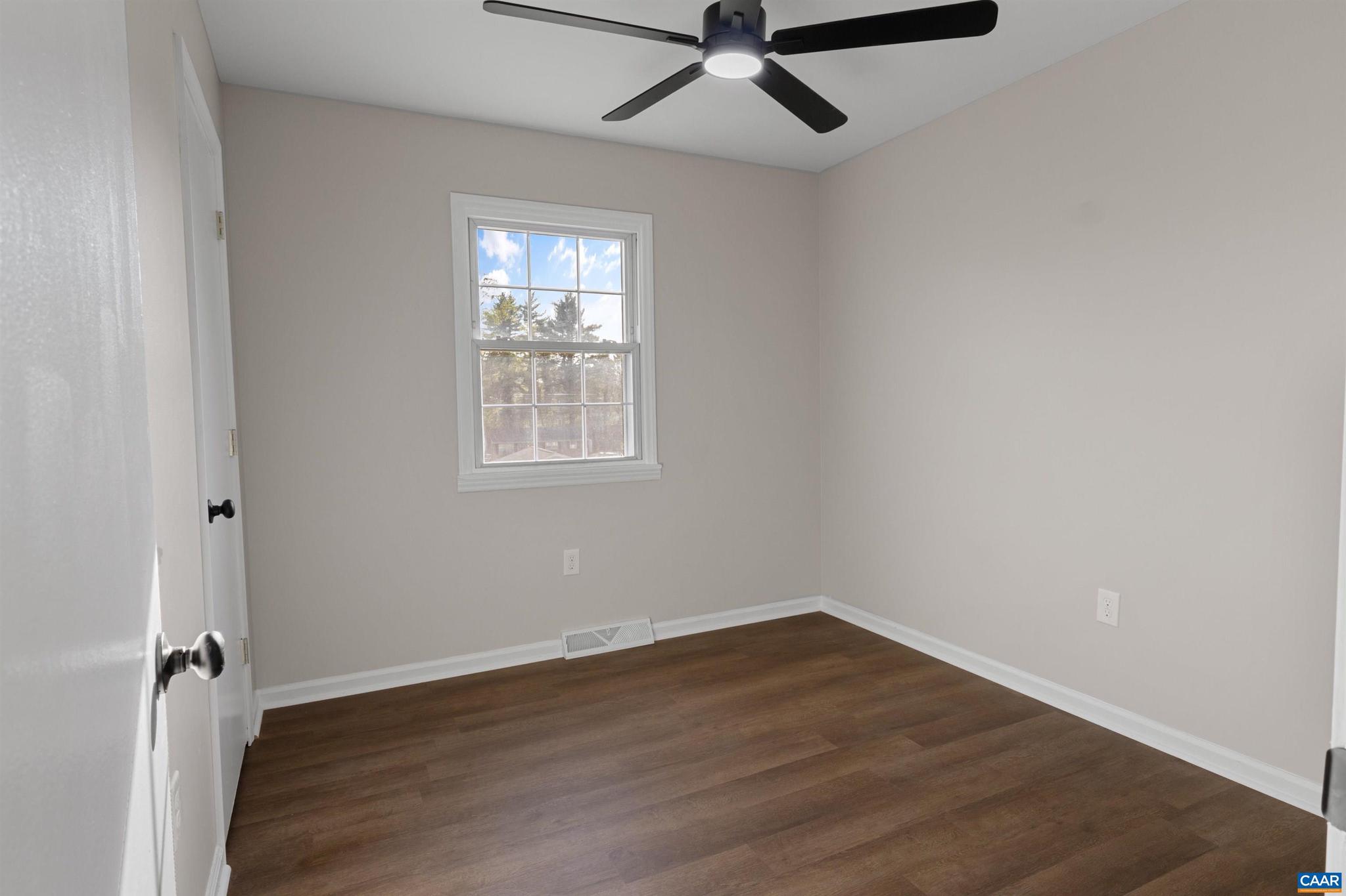 3053 Woodway Road Roanoke, VA 24014 - Photo 18 of 33 an empty room with wooden floor fan and windows