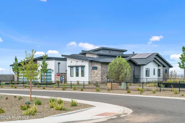 a front view of a house with a garden and plants