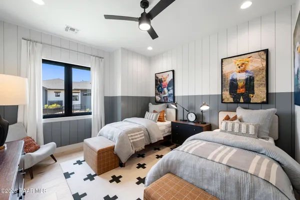 a bedroom with two beds and a window