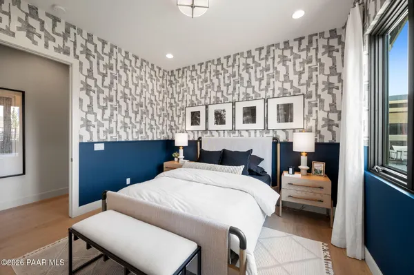 a bedroom with a bed and wooden floor