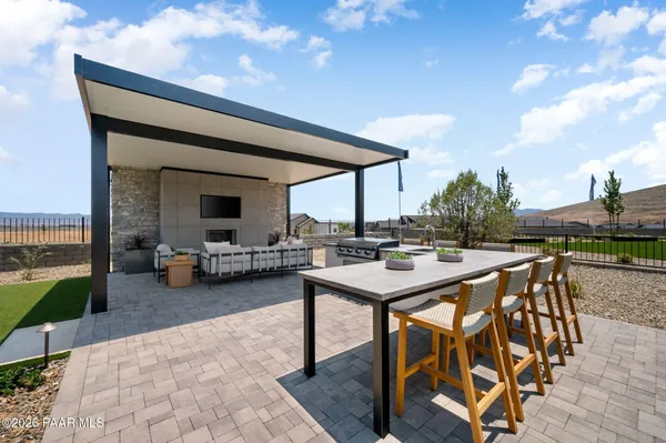 a view of a patio with a table and chairs