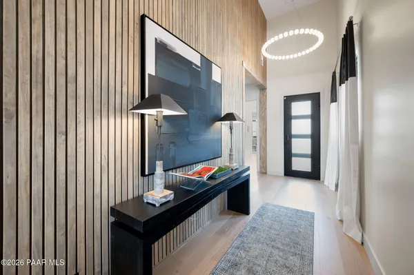 a hallway with furniture and next to a window