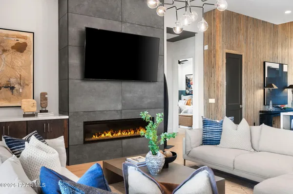 a living room with furniture a flat screen tv and a fireplace