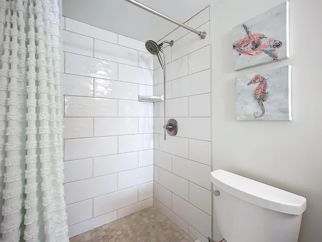 a bedroom with two beds and painting on the wall