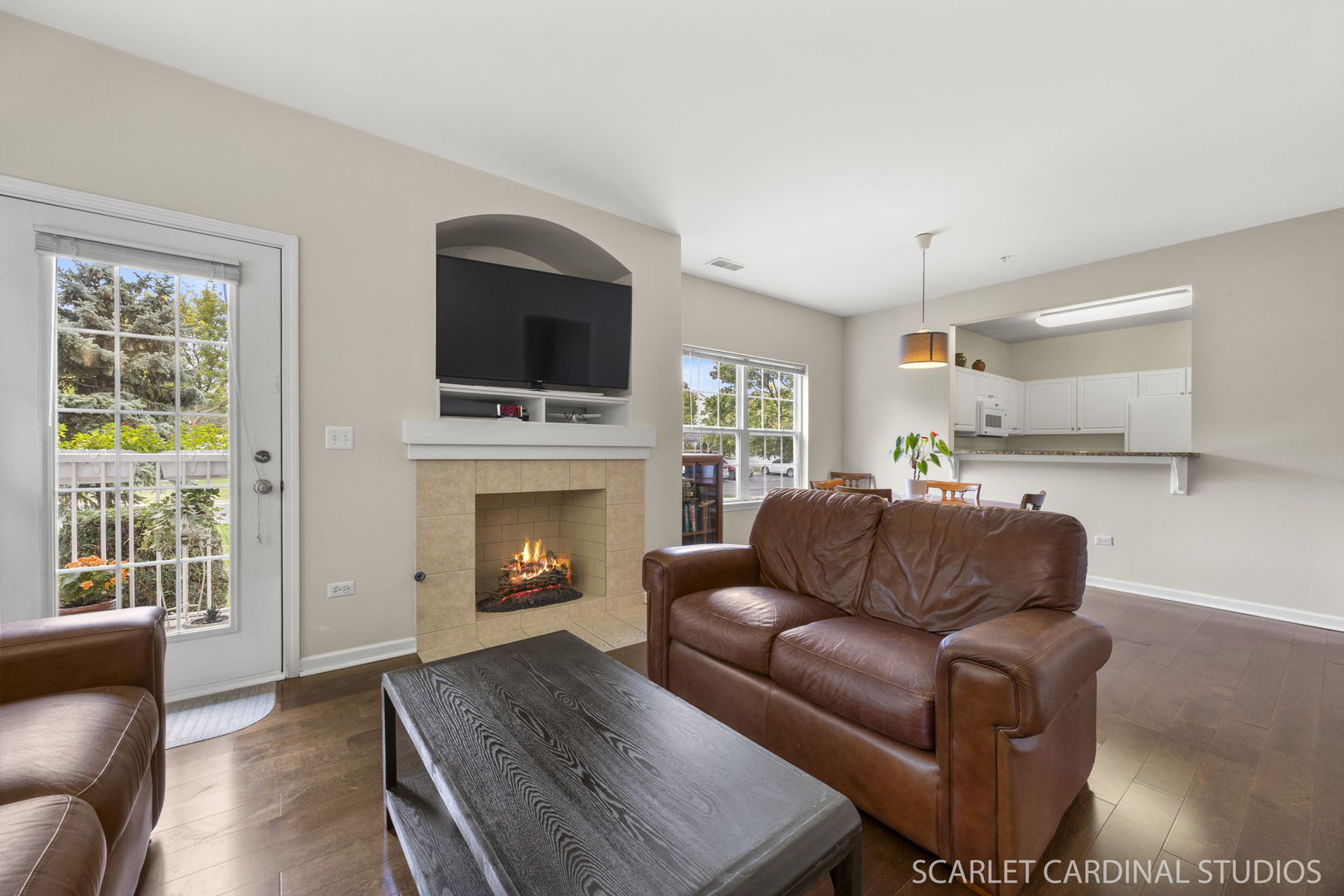1275 West Lake Street, Unit 104 Addison, IL 60101 - Photo 11 of 20 a living room with furniture a fireplace and a flat screen tv