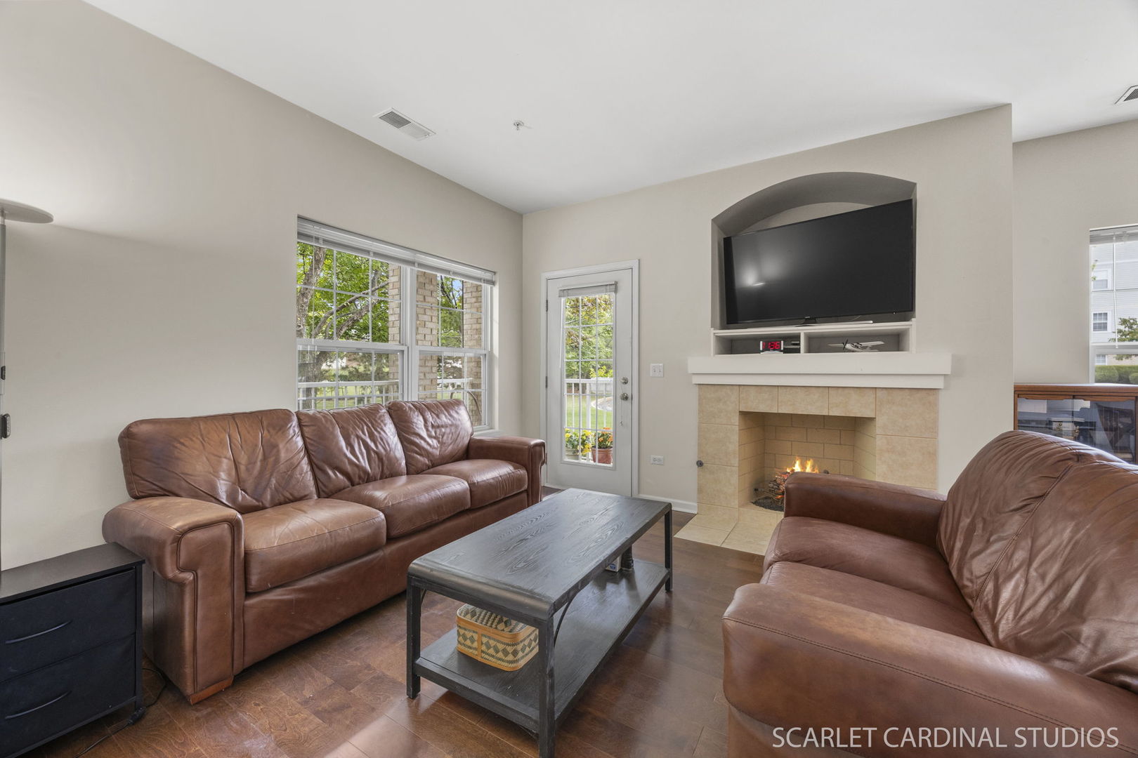 1275 West Lake Street, Unit 104 Addison, IL 60101 - Photo 12 of 20 a living room with furniture a flat screen tv and a fireplace