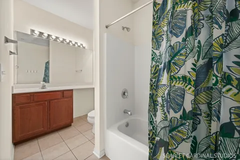 a bathroom with a granite countertop sink and a bathtub