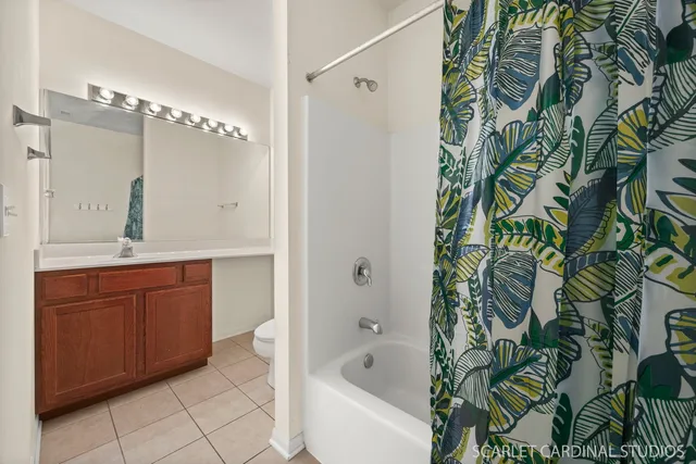 a bathroom with a granite countertop sink and a bathtub