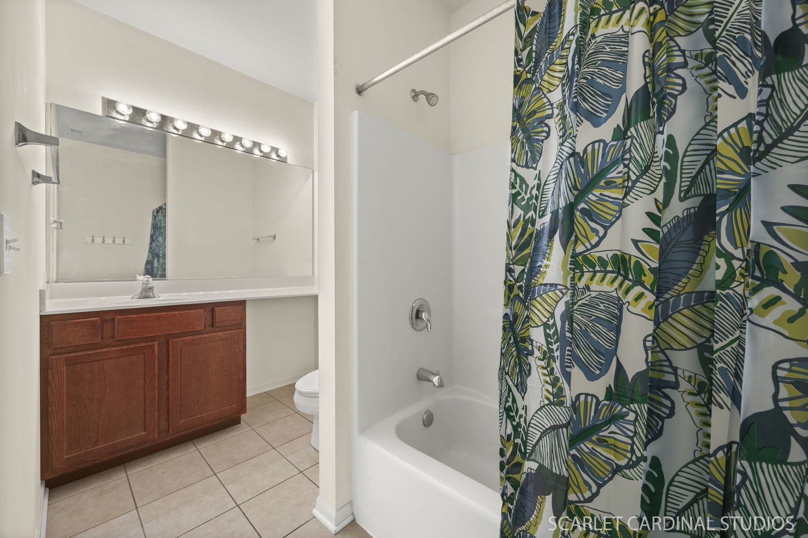 1275 West Lake Street, Unit 104 Addison, IL 60101 - Photo 17 of 20 a bathroom with a granite countertop sink and a bathtub