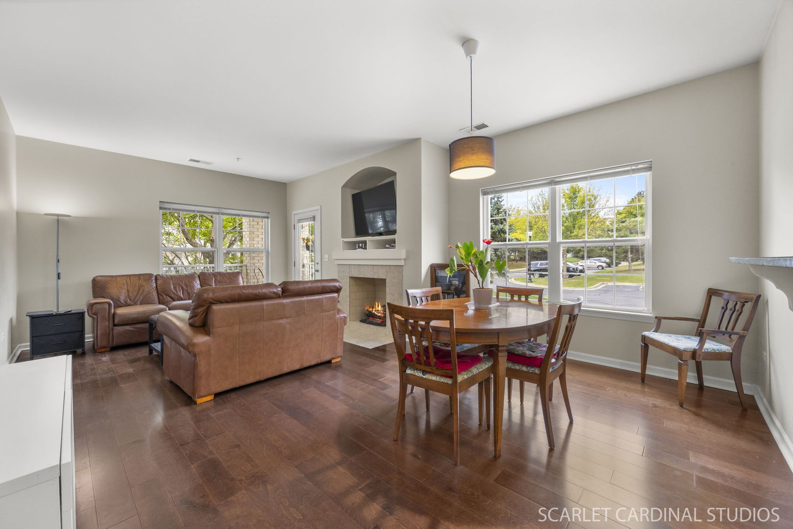 1275 West Lake Street, Unit 104 Addison, IL 60101 - Photo 6 of 20 a living room with furniture a dining table and a floor to ceiling window