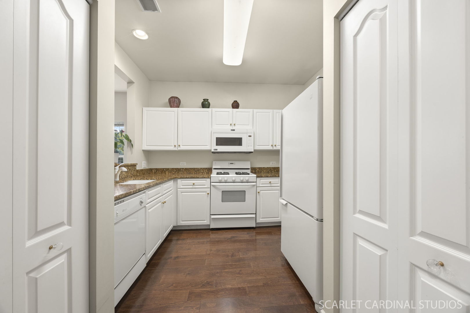 1275 West Lake Street, Unit 104 Addison, IL 60101 - Photo 9 of 20 a kitchen with granite countertop white cabinets and white appliances