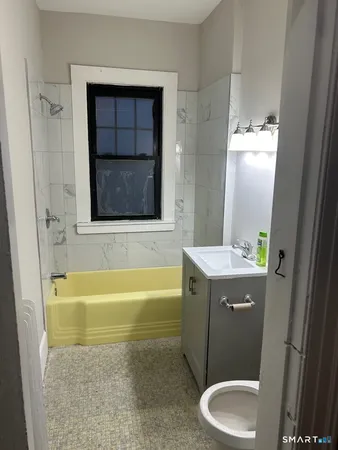 a bathroom with a sink a toilet and bathtub