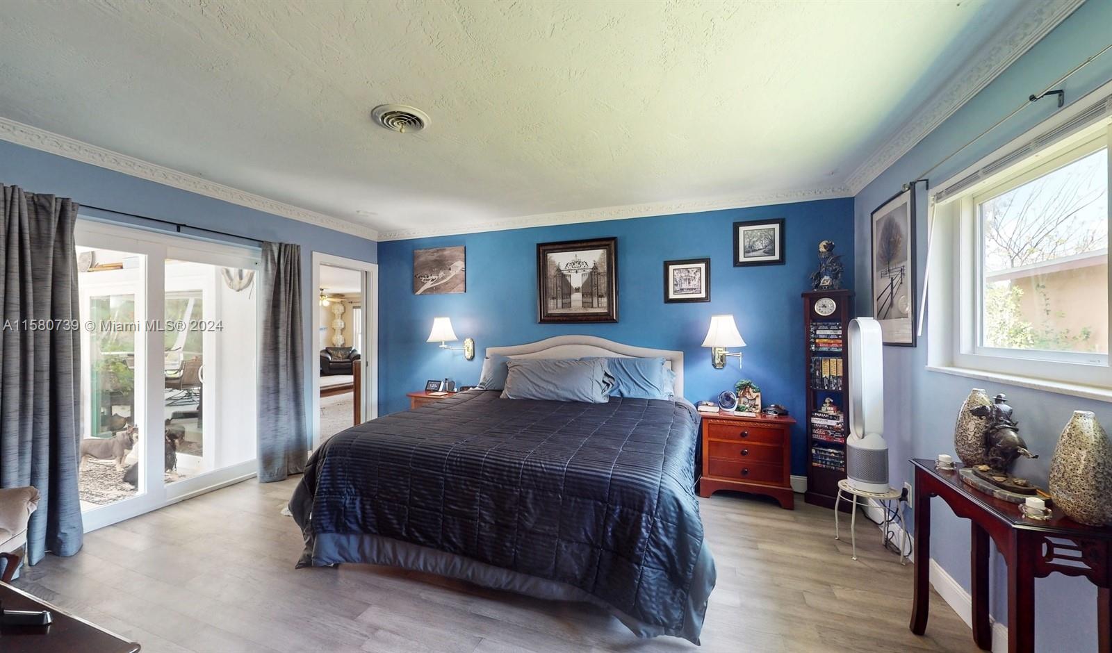 5424 Harrison Street Hollywood, FL 33021 - Photo 11 of 27 a bedroom with a bed and wooden floor