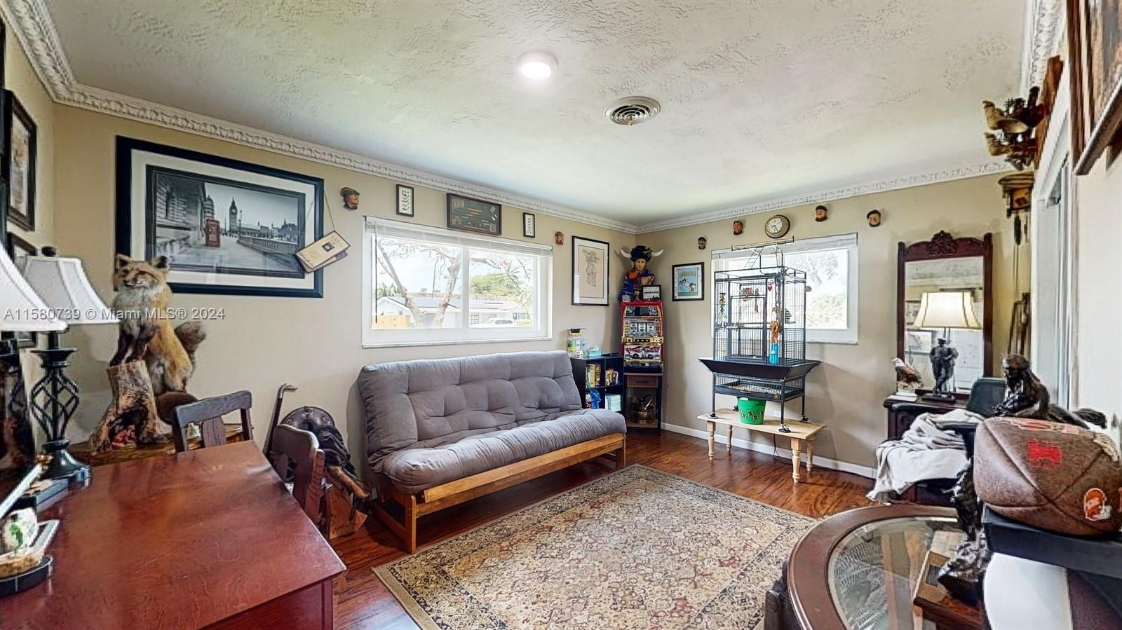 5424 Harrison Street Hollywood, FL 33021 - Photo 16 of 27 a living room with furniture a rug and a window