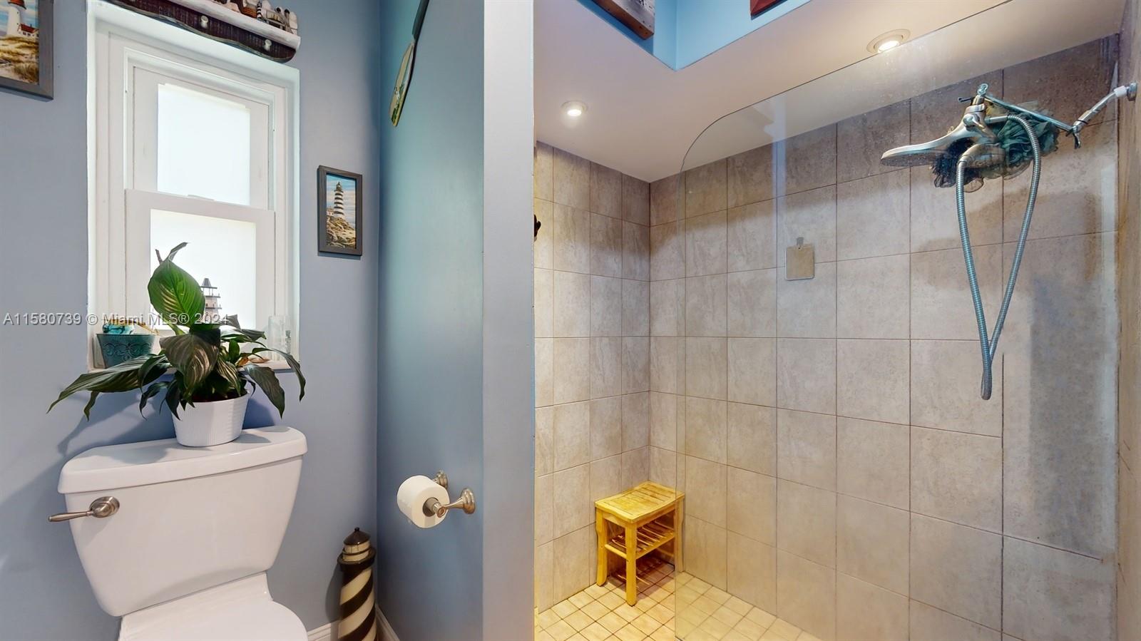 5424 Harrison Street Hollywood, FL 33021 - Photo 19 of 27 a bathroom with a toilet and a shower