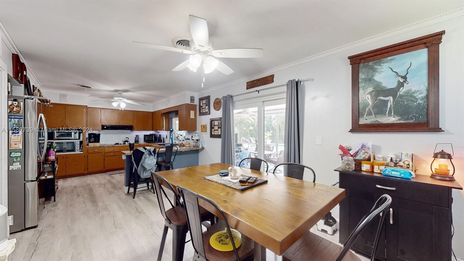 5424 Harrison Street Hollywood, FL 33021 - Photo 21 of 27 a view of a dining room with furniture and a chandelier