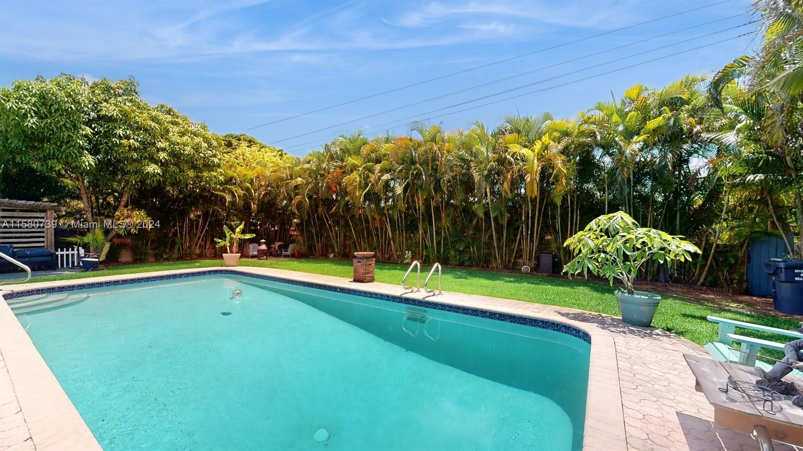 5424 Harrison Street Hollywood, FL 33021 - Photo 22 of 27 a view of a swimming pool with an outdoor space and seating area