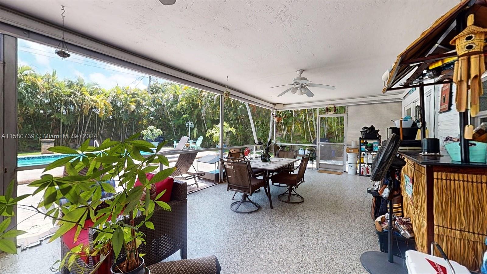 5424 Harrison Street Hollywood, FL 33021 - Photo 24 of 27 a living room with patio furniture and a potted plant
