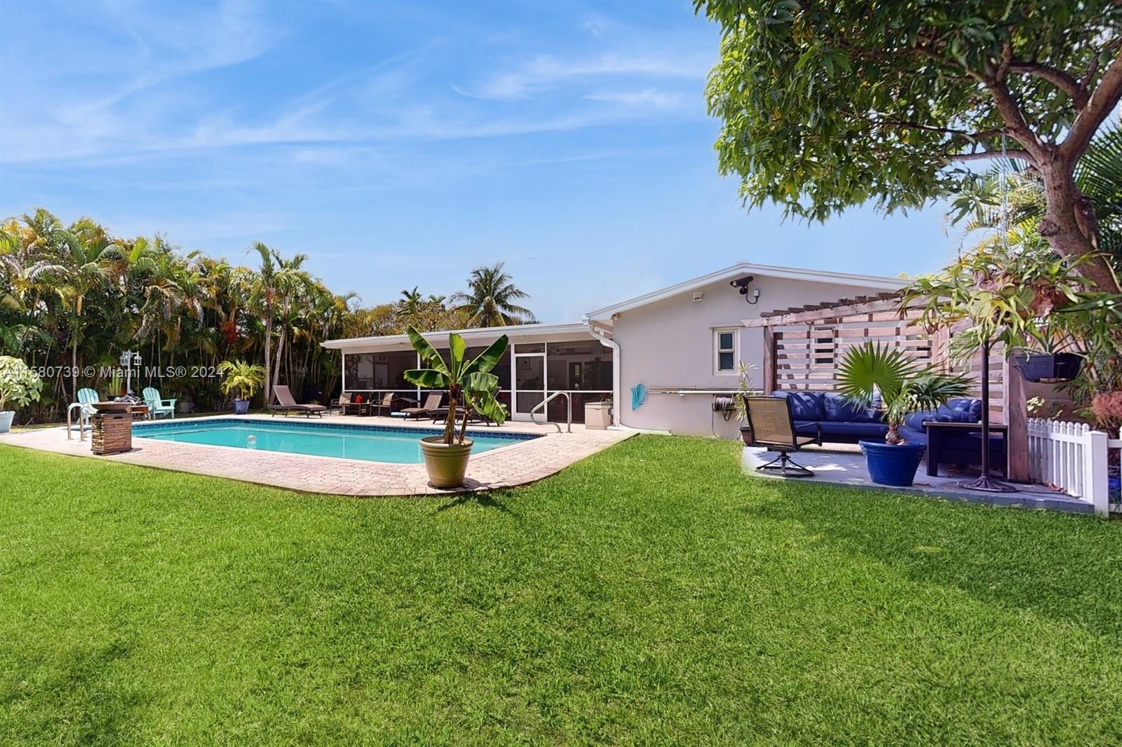5424 Harrison Street Hollywood, FL 33021 - Photo 25 of 27 a view of a house with swimming pool and a yard