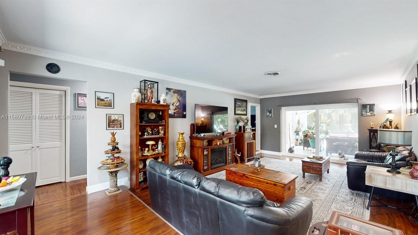 5424 Harrison Street Hollywood, FL 33021 - Photo 3 of 27 a living room with furniture and a flat screen tv
