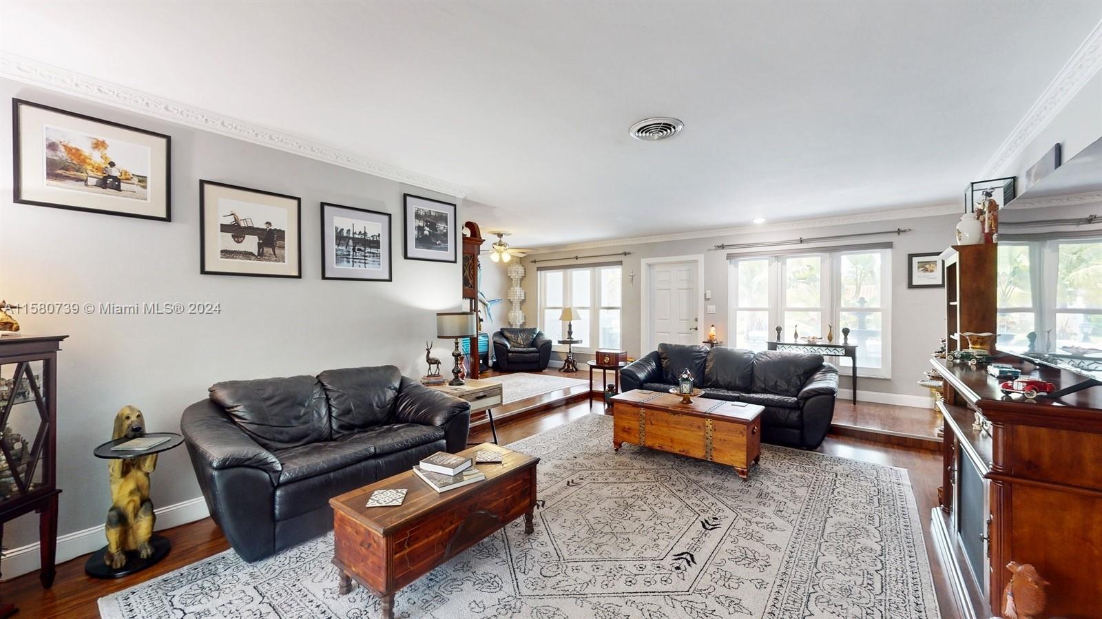 5424 Harrison Street Hollywood, FL 33021 - Photo 4 of 27 a living room with furniture couches and a flat screen tv