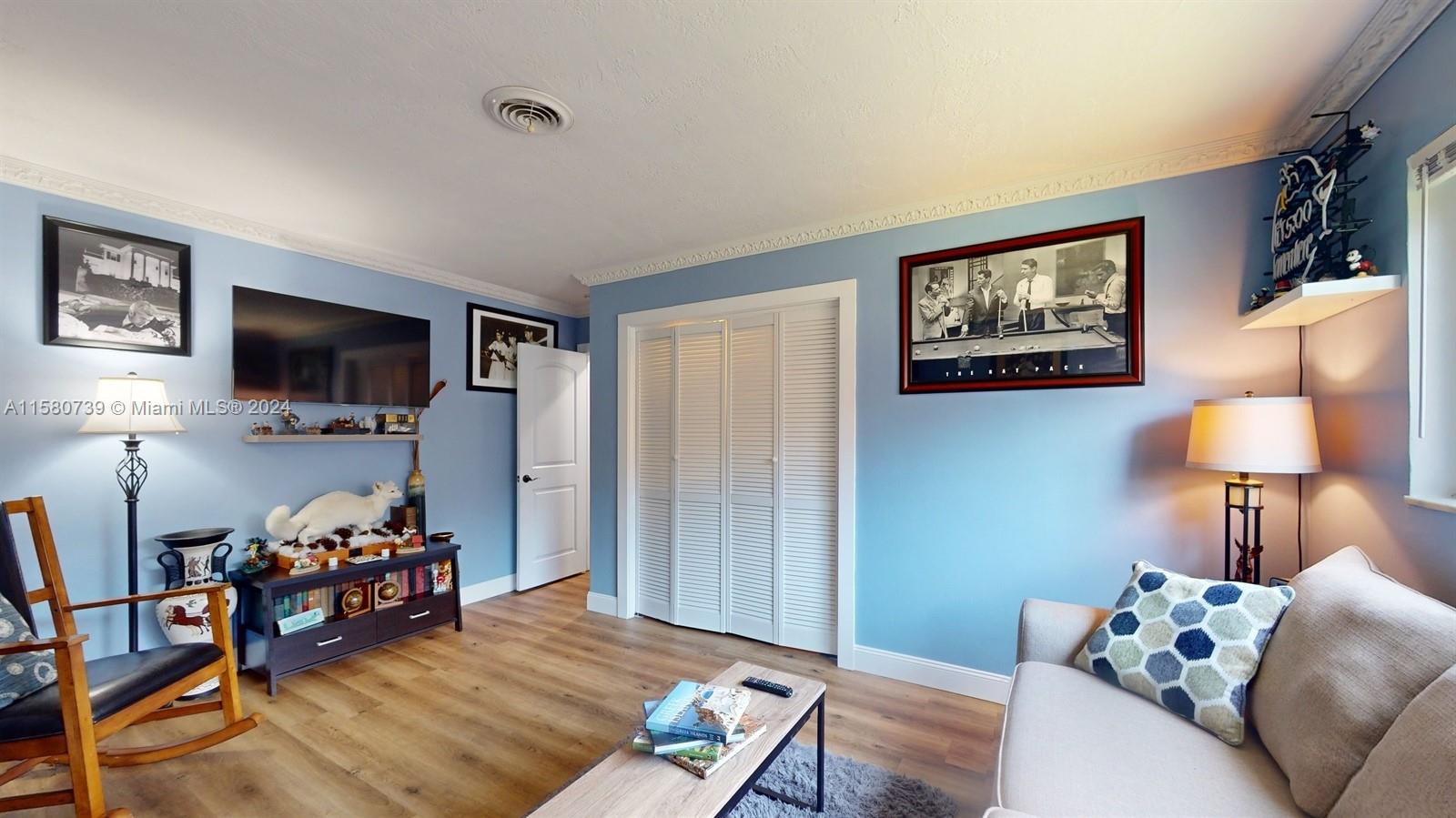 5424 Harrison Street Hollywood, FL 33021 - Photo 7 of 27 a living room with furniture and a flat screen tv