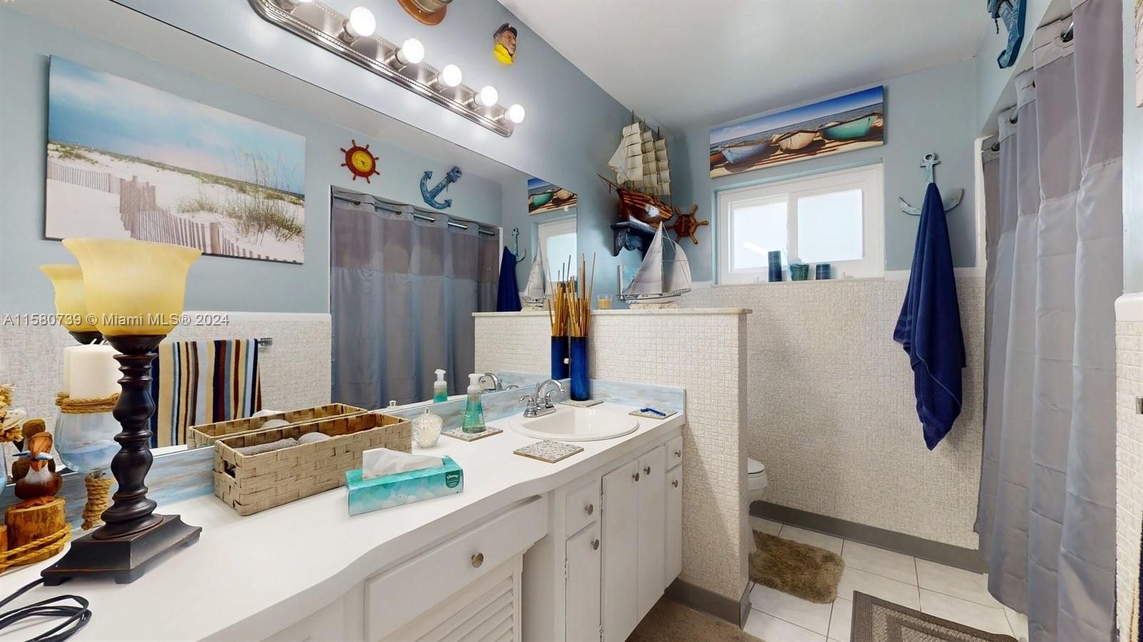 5424 Harrison Street Hollywood, FL 33021 - Photo 9 of 27 a bathroom with a sink double vanity and a mirror