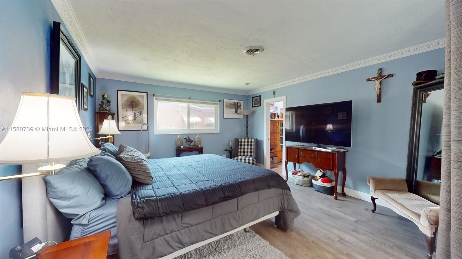 5424 Harrison Street Hollywood, FL 33021 - Photo 10 of 27 a bedroom with furniture and a flat screen tv