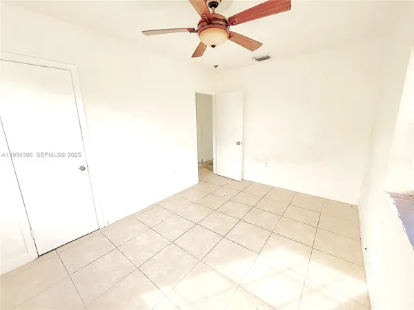 a view of an empty room and a window