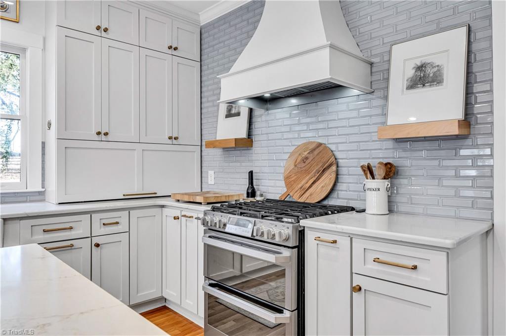 7042 Brookbank Road Summerfield, NC 27358 - Photo 13 of 50 Beautiful new appliances, backsplash & fixtures throughout.