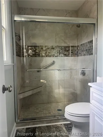 a bathroom with a toilet and a shower